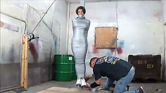 Voluptuous Woman Bound To A Post With Duck Tape